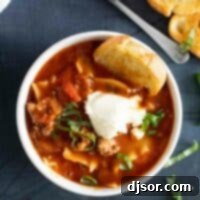 overhead view of a bowl of Lasagna Soup topped with ricotta cheese