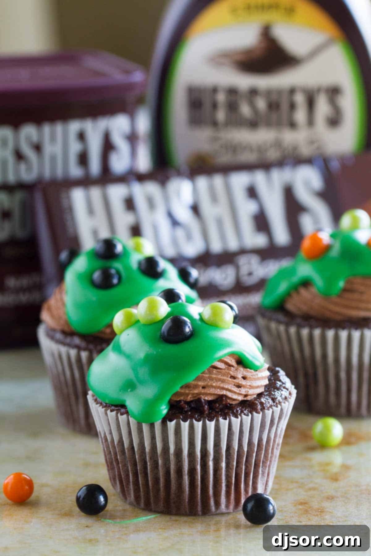 Ultimate Chocolate Cupcakes decorated for Halloween with vibrant green ganache and festive candy toppings, showcasing a spooky yet delicious treat.