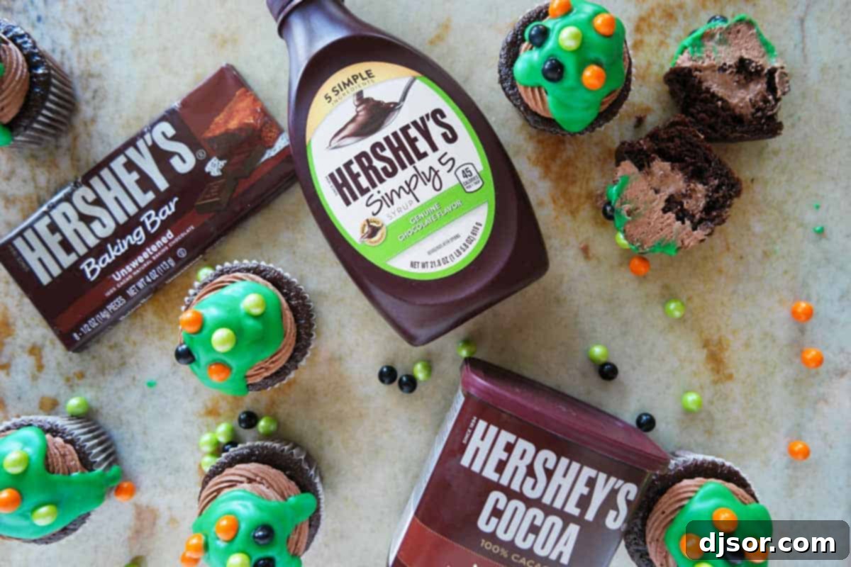 Various HERSHEY'S chocolate products, including baking bars, cocoa, and white chips, neatly arranged for making Ultimate Chocolate Cupcakes.