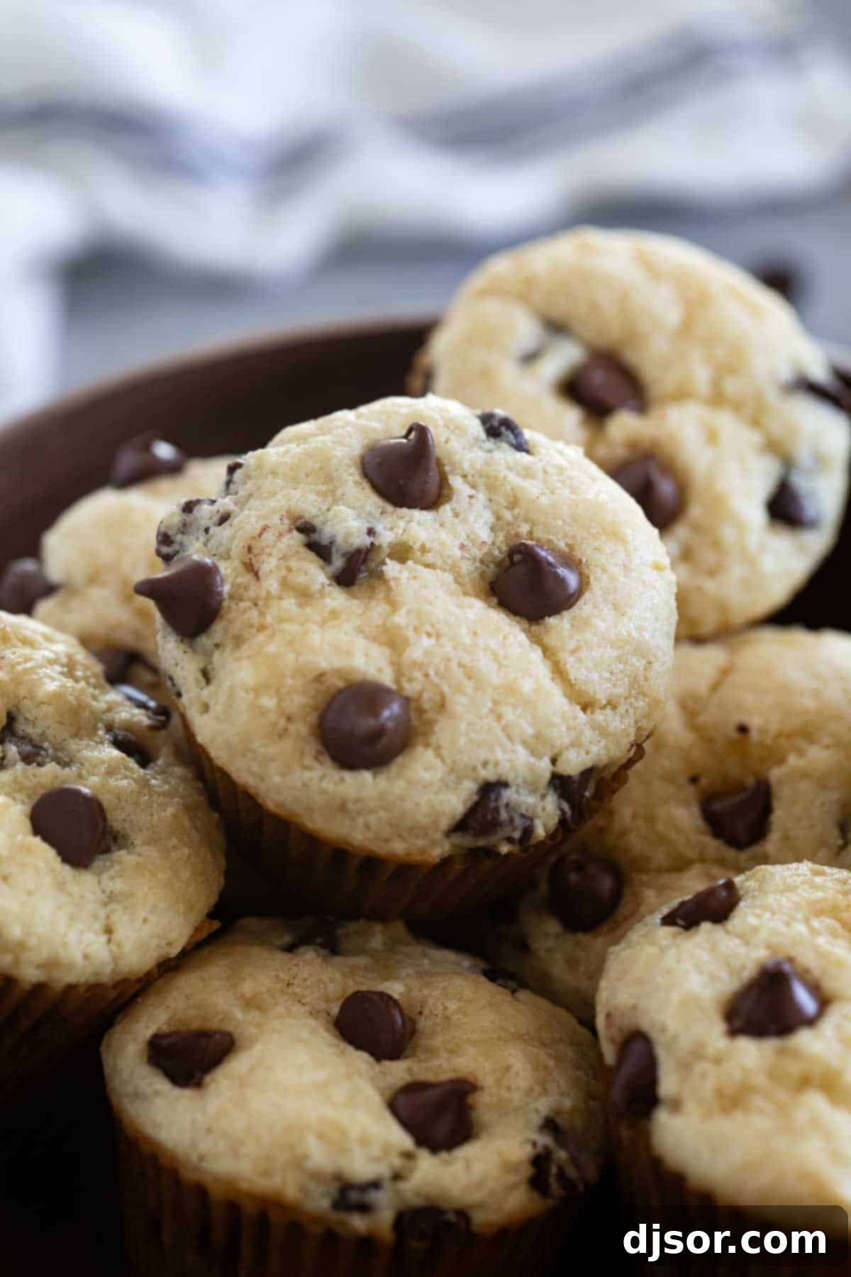 Bowl filled with Sour Cream Muffins with Chocolate Chips.
