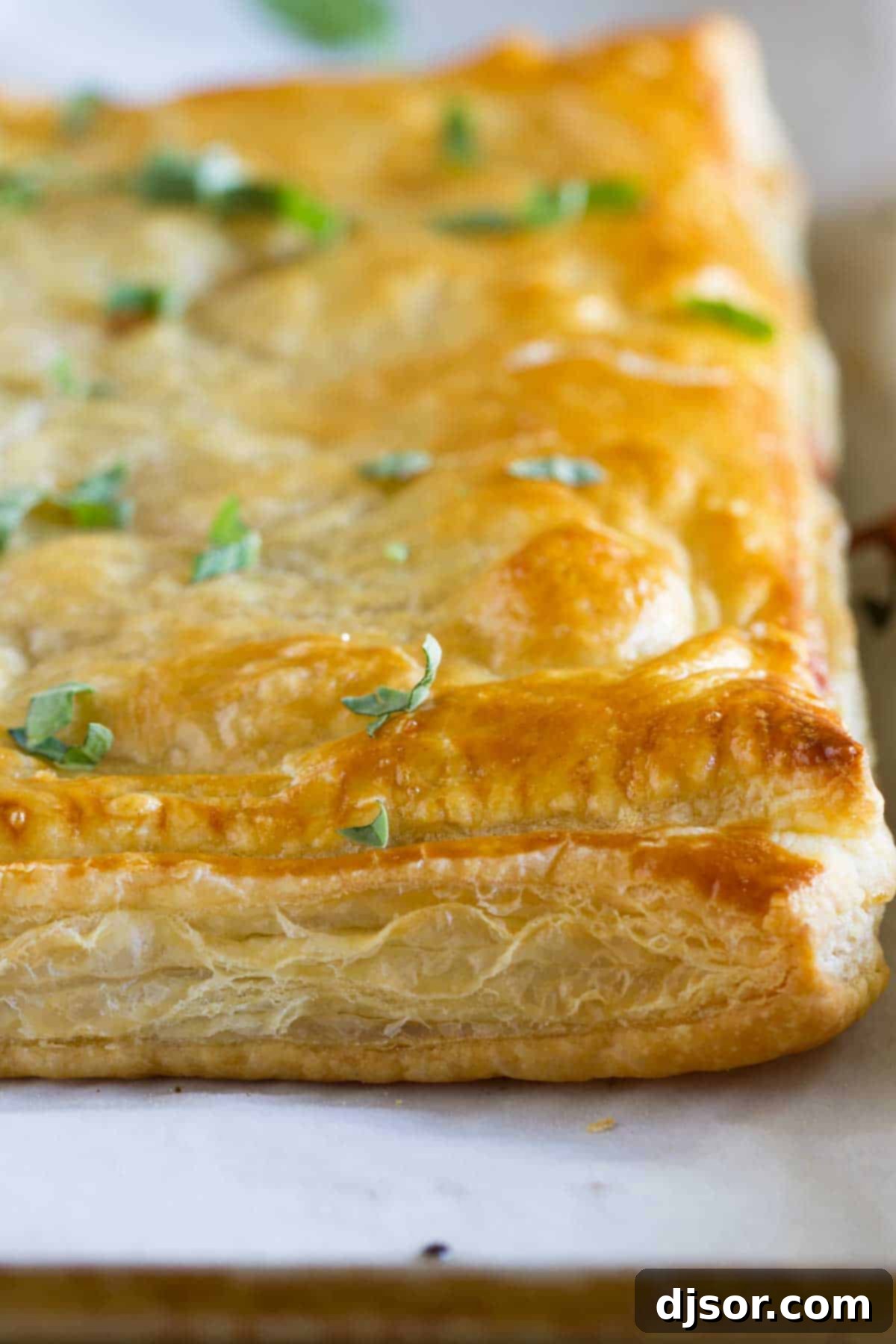 A full view of the golden-brown Sausage and Butternut Squash Slab Pie, fresh out of the oven, made with puff pastry.