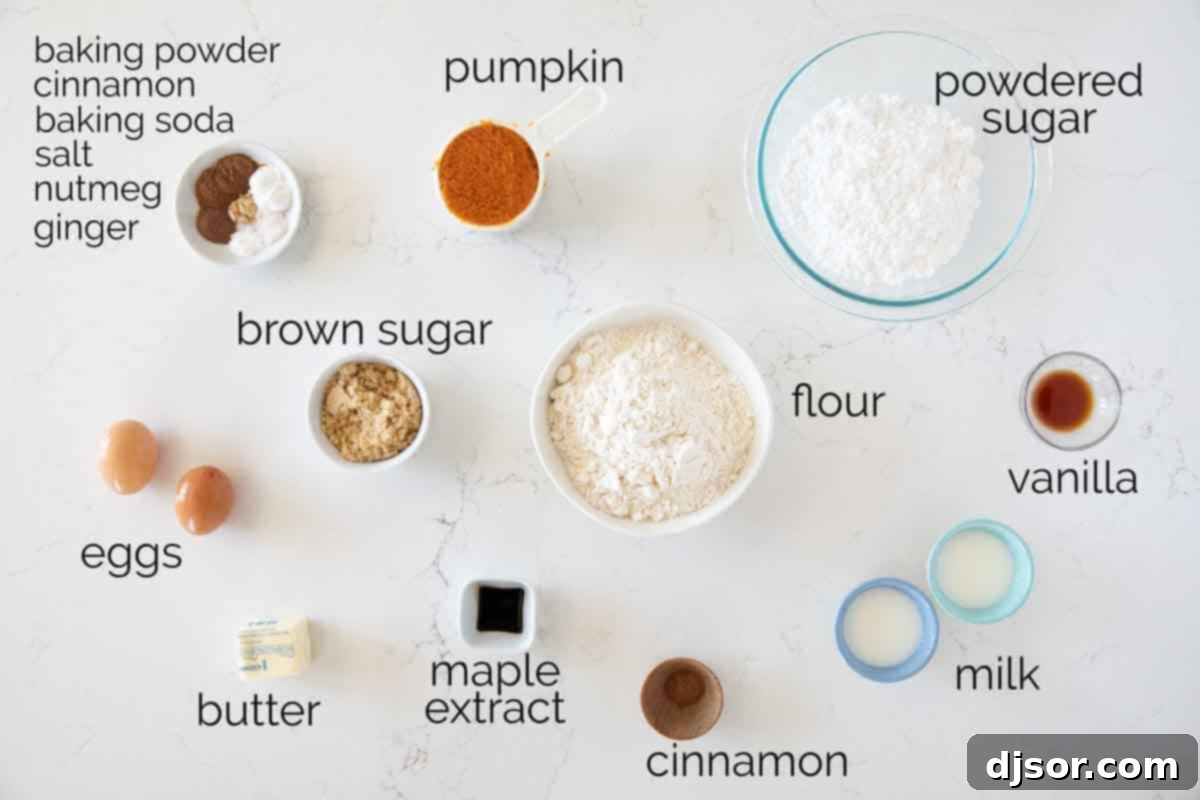 A selection of fresh ingredients laid out, including flour, sugar, pumpkin puree, eggs, butter, and various spices, ready for making baked pumpkin donuts.