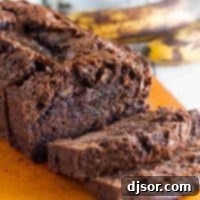 Loaf of sliced Brownie Mix Banana Bread on a cutting board.