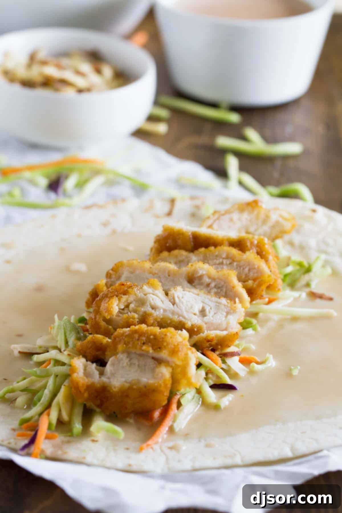 Sticky Honey Sesame Chicken Wraps 4 Unwrapped honey sesame chicken salad wrap with crispy chicken and fresh ingredients visible.