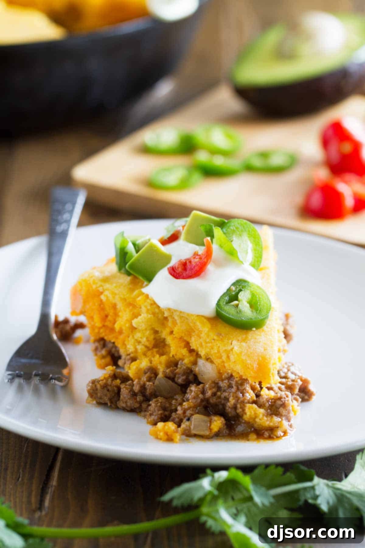 A delectable slice of Skillet Tamale Pie served on a plate, showcasing its golden cornbread topping and savory filling.
