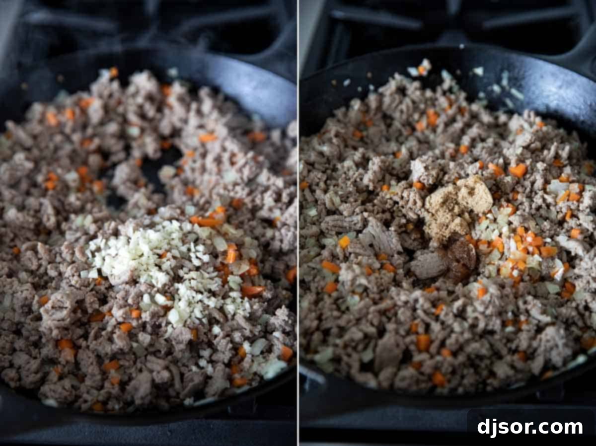 Infusing Flavor: Adding Garlic and Seasonings to Turkey Sloppy Joe Mixture Freshly minced garlic being added to the browned ground turkey, carrots, and onions in a skillet, along with various seasonings, ready to develop the rich sloppy joe sauce.