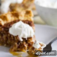 Fork full of coconut pecan pie on a plate.