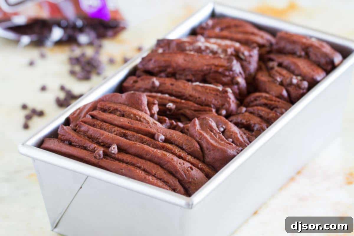 Decadent Chocolate Pull-Apart Loaf 3 Chocolate pull apart bread baking in a loaf pan, showing its individual layers