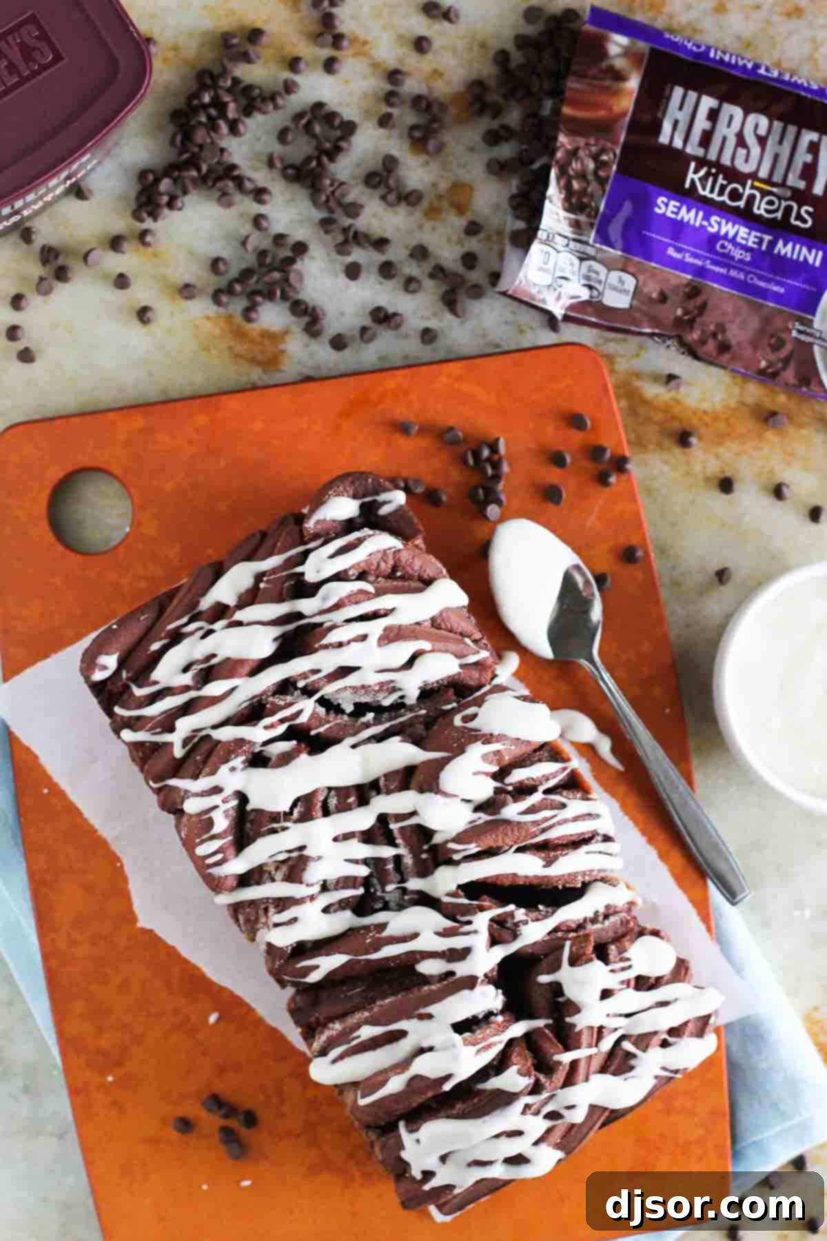 Decadent Chocolate Pull-Apart Loaf 5 Chocolate Pull Apart Bread with mini chocolate chips visible on a cutting board, ready to be served