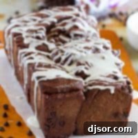 Decadent Chocolate Pull-Apart Loaf 7 Loaf of chocolate pull apart bread drizzled with icing, ready to be served.