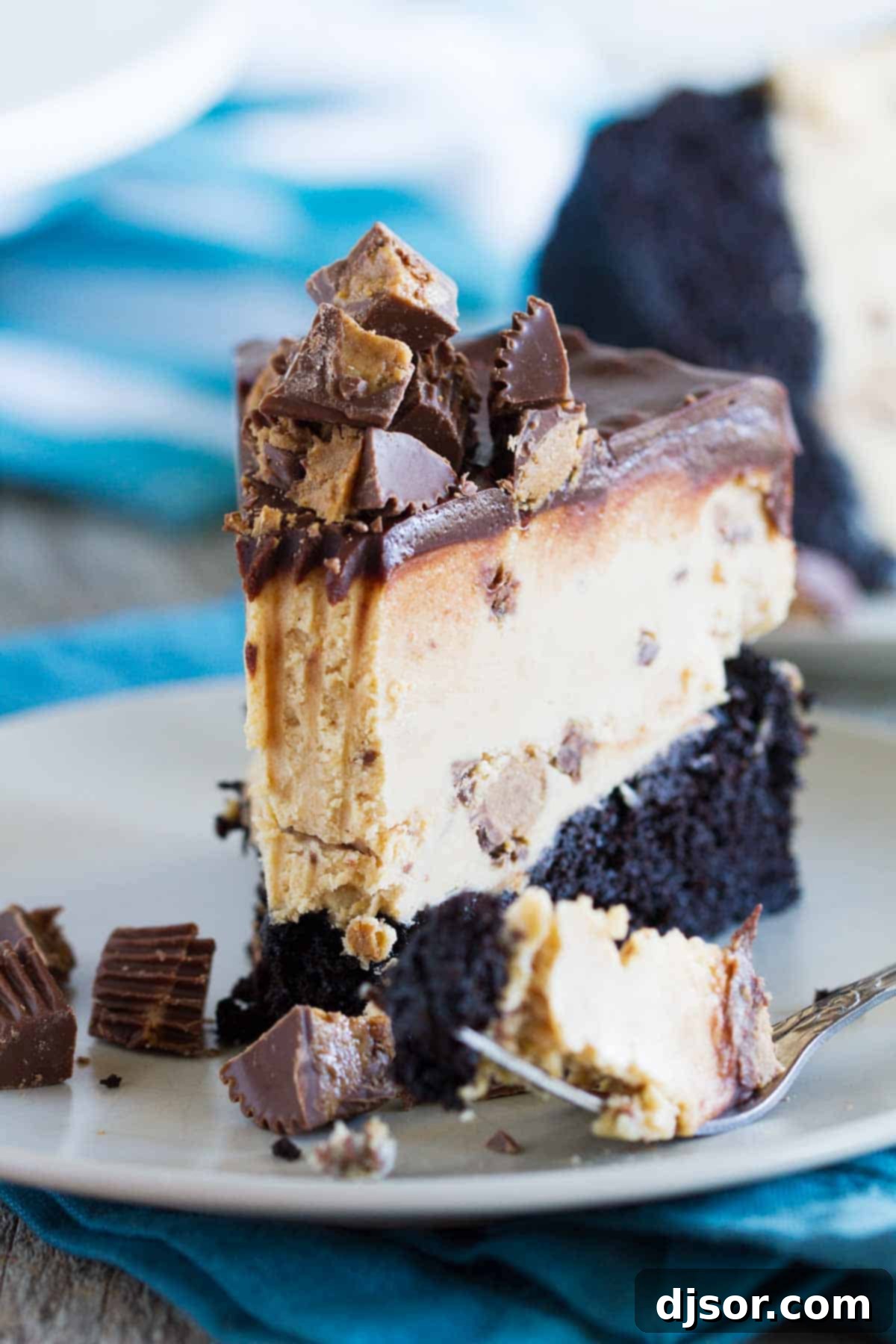 Ultimate Peanut Butter Cup Ice Cream Cake 5 Slice of peanut butter cup ice cream cake with a bite taken from it.