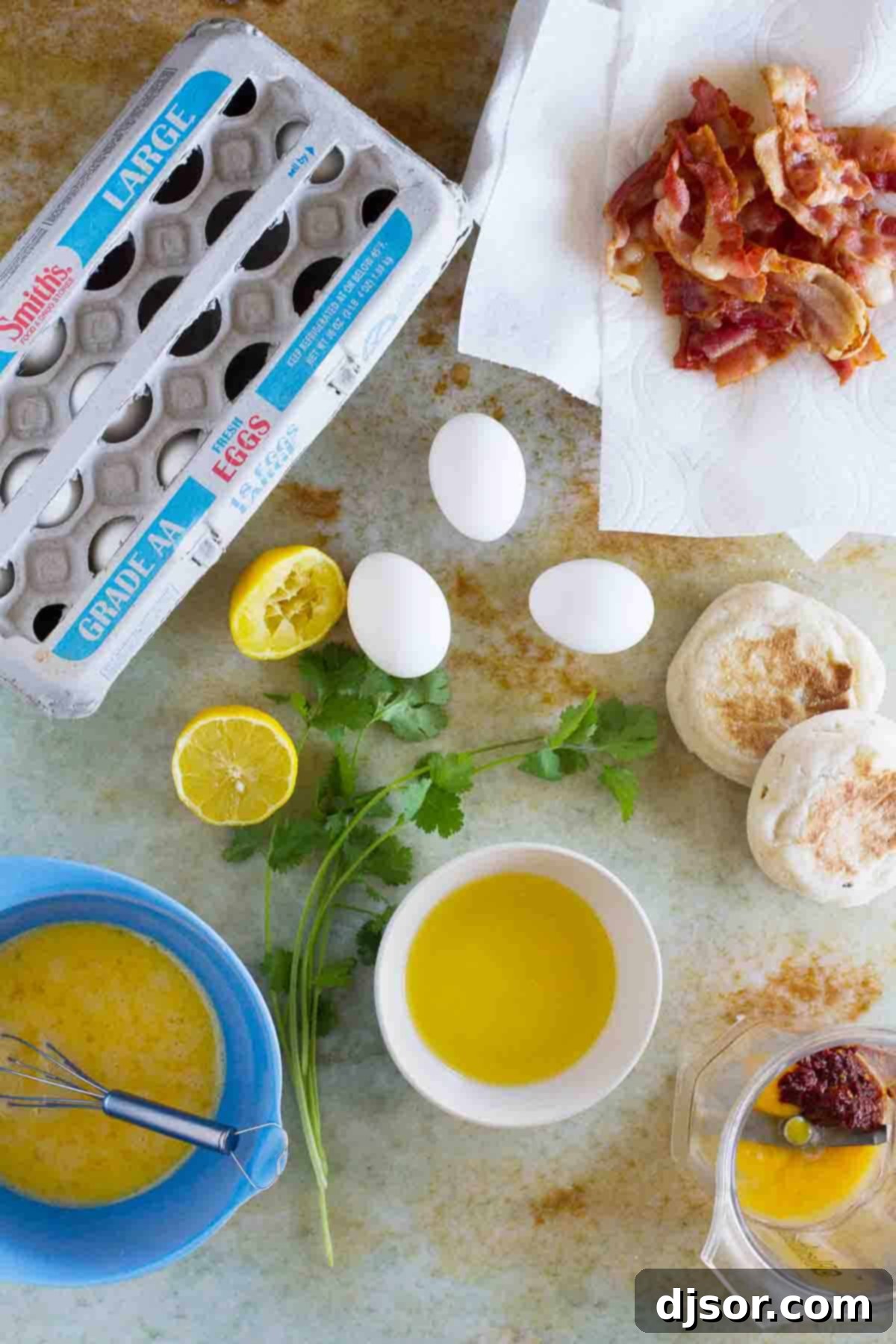 overhead view of ingredients needed to make Bacon and Eggs Benedict Sandwich