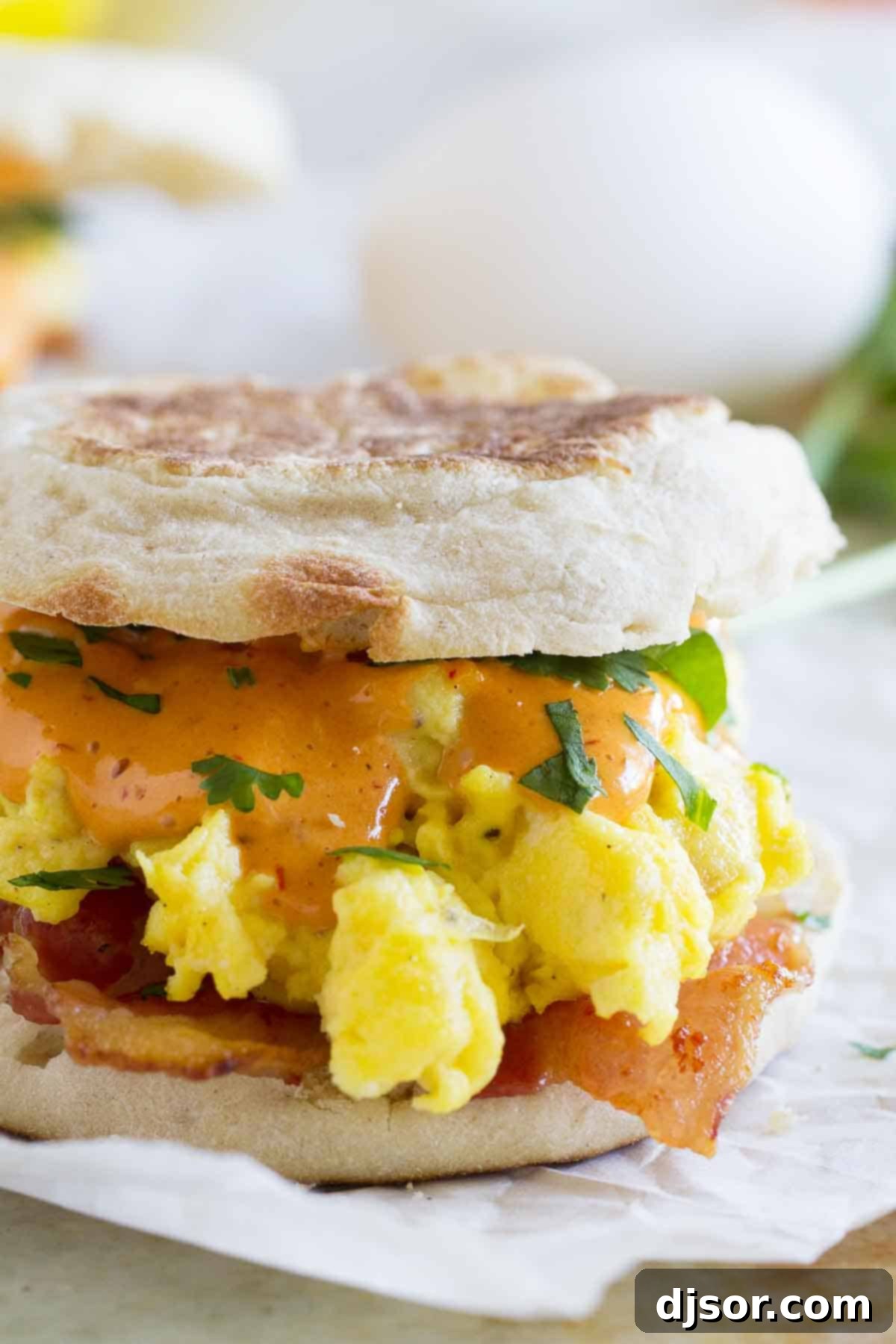 close up photo of bacon and eggs benedict sandwich