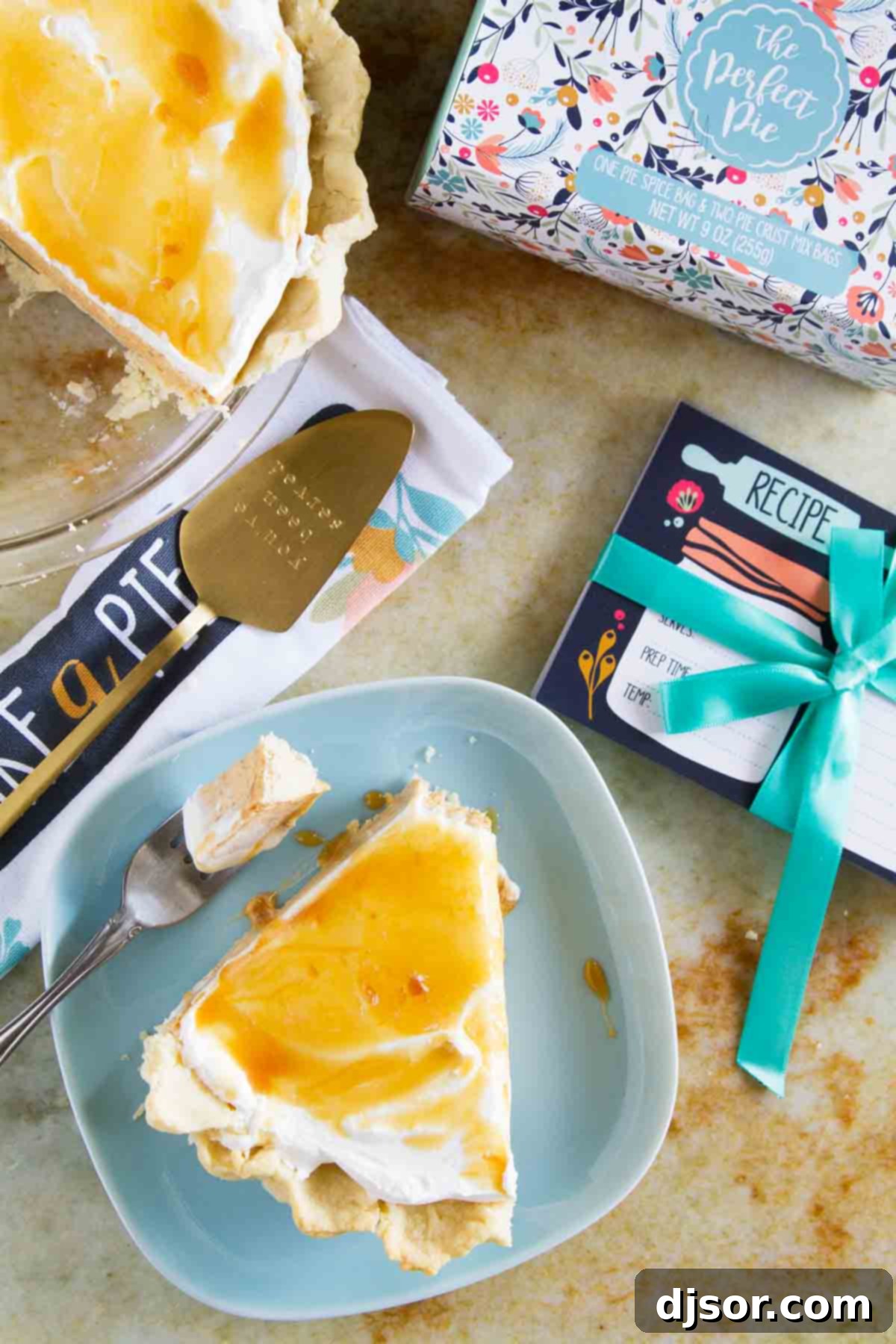 A scrumptious slice of White Chocolate Caramel No Bake Pumpkin Pie on a vibrant blue plate, with a fork showcasing a delightful bite.