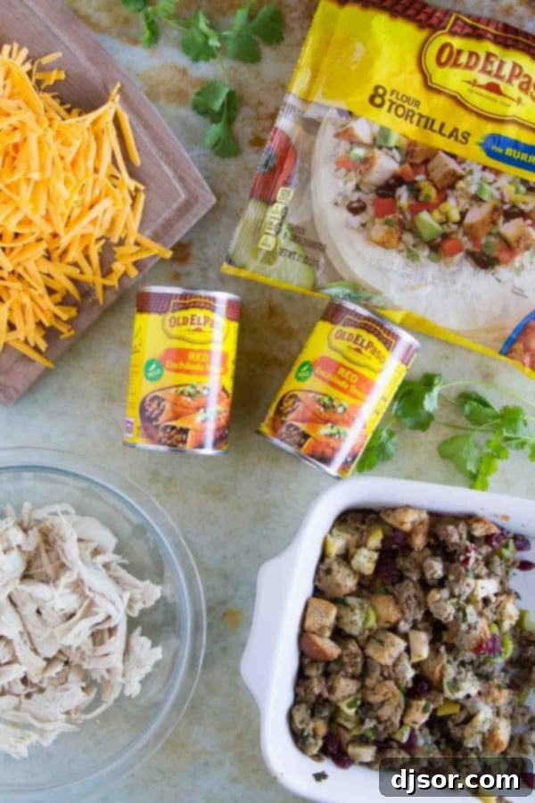 Thanksgiving Encore Enchiladas 3 Close-up of Thanksgiving Leftover Enchiladas baking in a dish, showing melted cheese and bubbling red sauce.