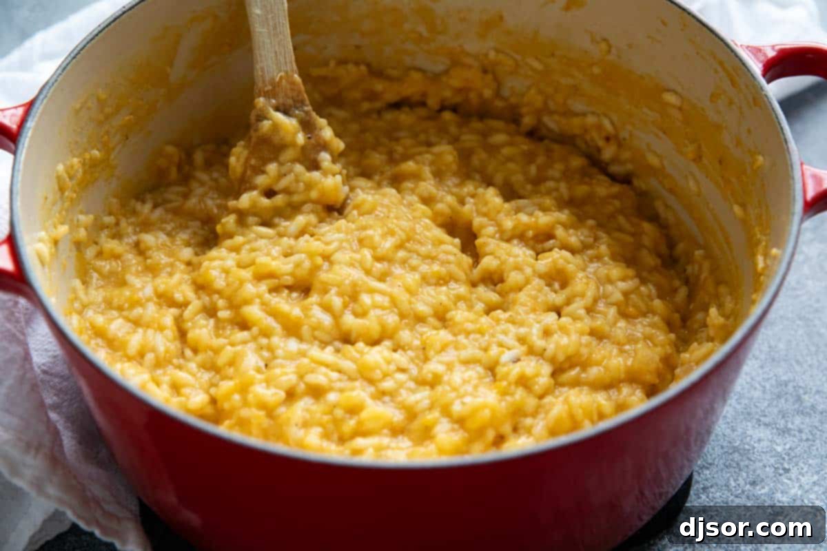 Golden Butternut Risotto 7 A Dutch oven filled to the brim with creamy, golden butternut squash risotto, ready to be served.
