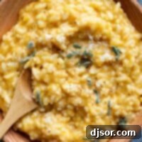 Golden Butternut Risotto 10 Butternut squash risotto topped with sage in a wooden bowl.