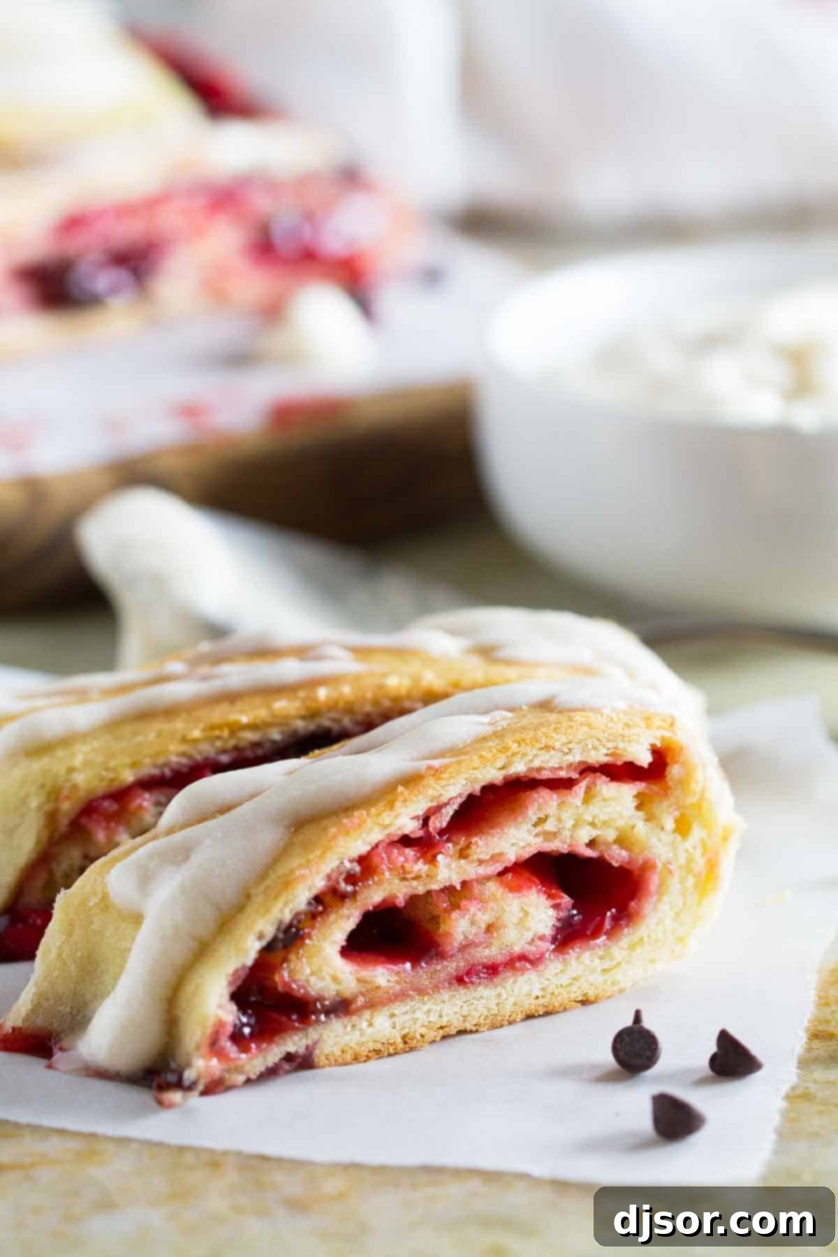 Close-up of a freshly baked Chocolate Cherry Roll, showcasing its golden-brown crust and tempting cherry and chocolate filling.