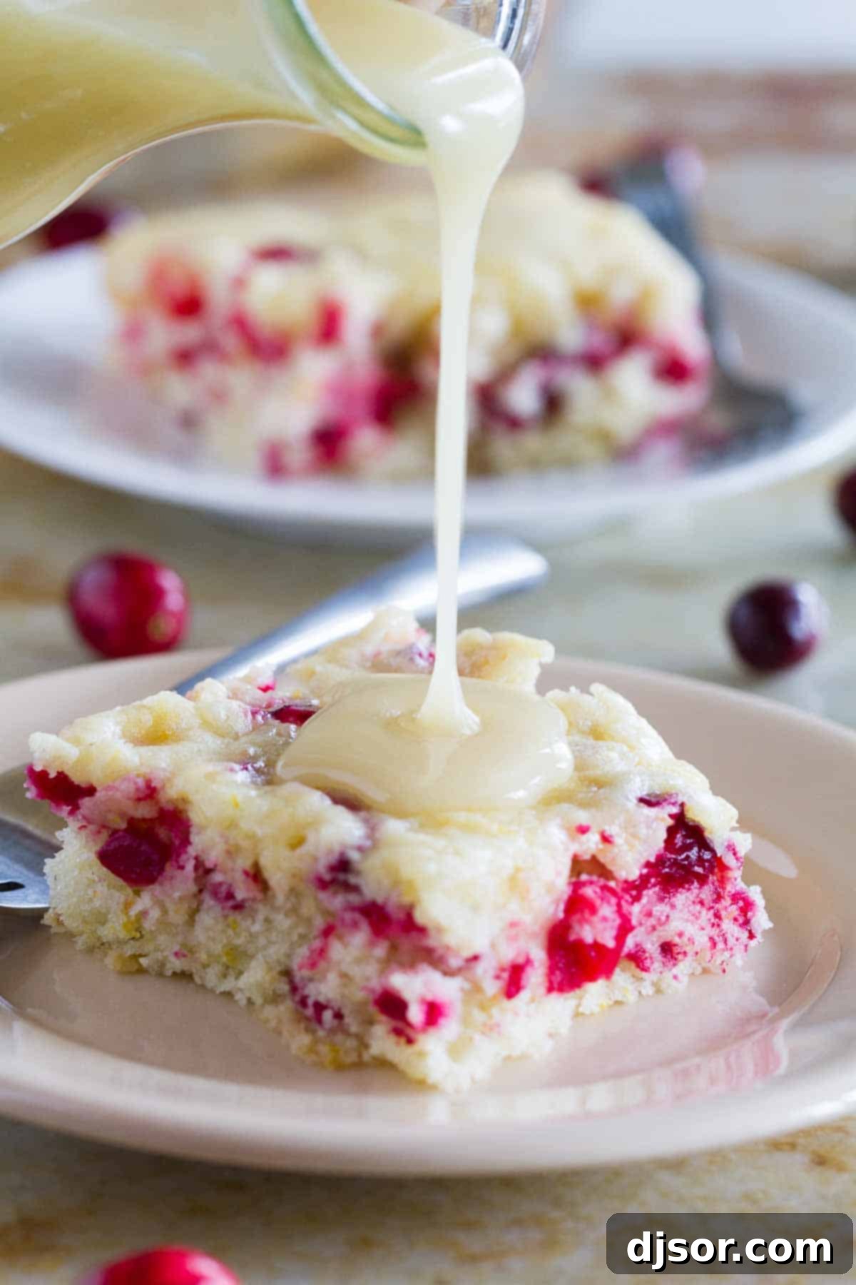pouring warm butter sauce over cranberry cake