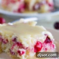 Slice of cranberry cake with warm butter sauce over the top
