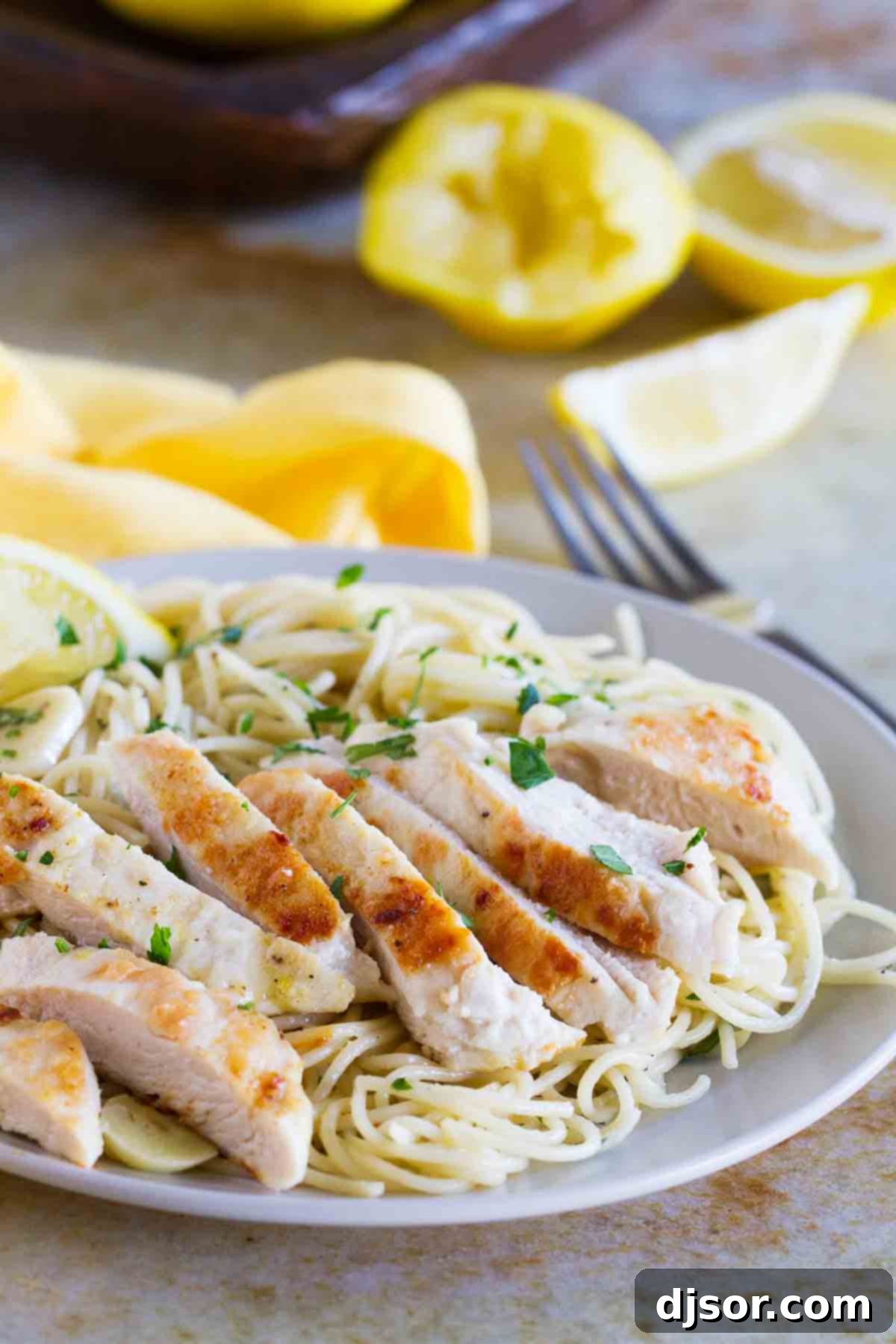 Lemon Chicken Pasta on a plate topped with fresh parsley