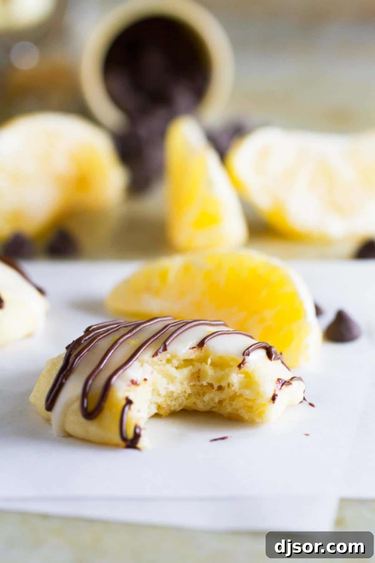 ricotta cookie drizzled with chocolate with a bite taken from it