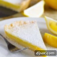 Slice of shortbread lemon tart on a plate.