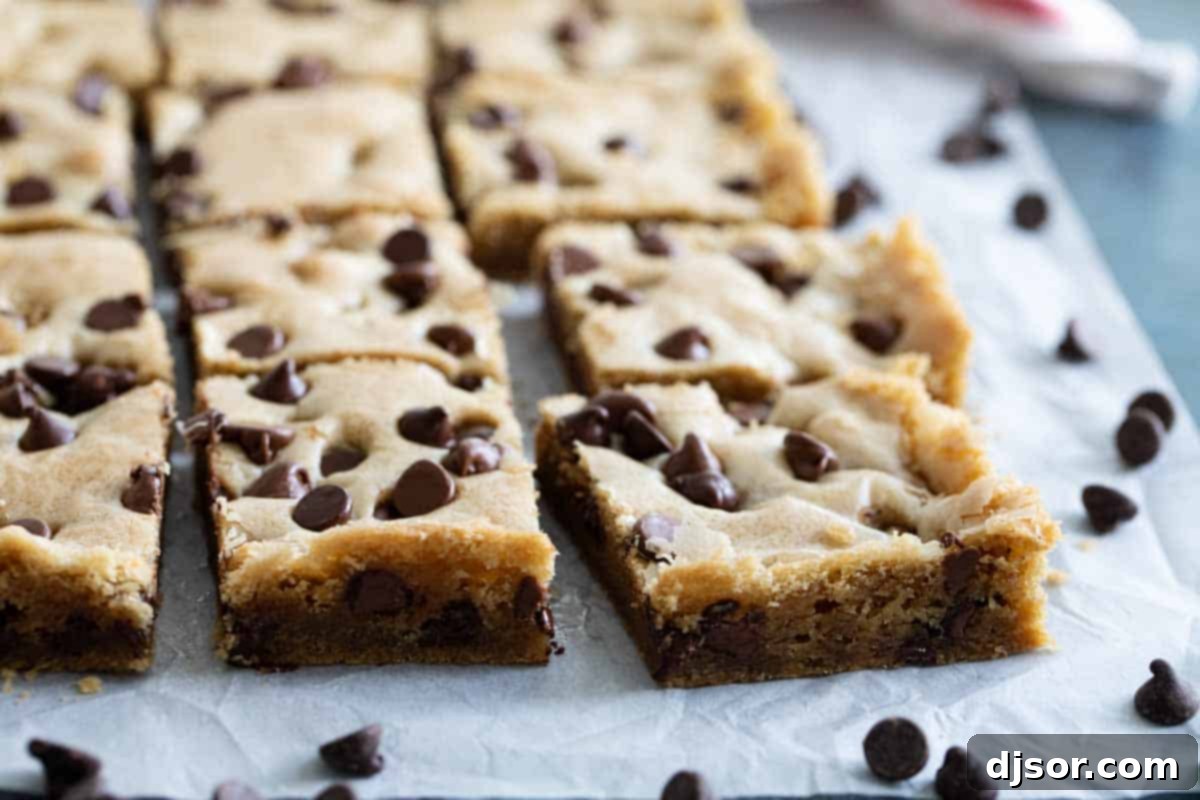Freshly baked Chocolate Chip Cookie Bars cut into perfect squares, showcasing their soft, golden-brown tops and generous chocolate distribution.
