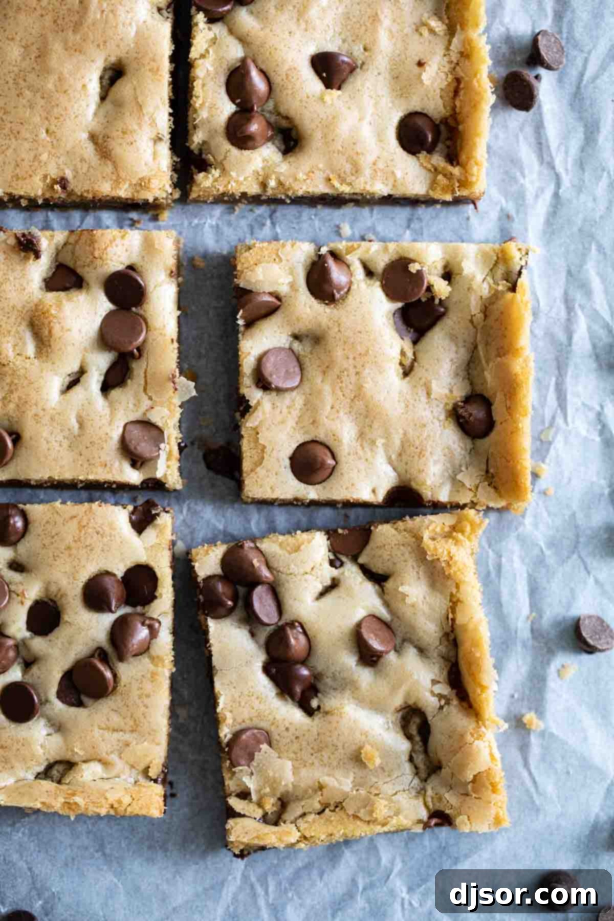 An overhead view of freshly baked, golden-brown Chocolate Chip Cookie Bars, glistening with melted chocolate chips, ready to be cooled and served.