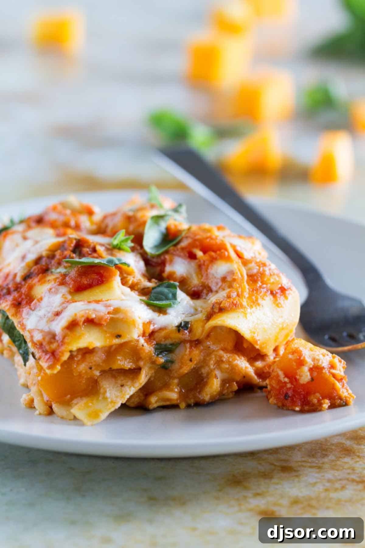 Enjoy a hearty slice of Skillet Butternut Squash Lasagna, a delightful and simple vegetarian meal. A perfectly portioned slice of Skillet Butternut Squash Lasagna, revealing its creamy layers and golden-brown top, inviting a delicious taste.