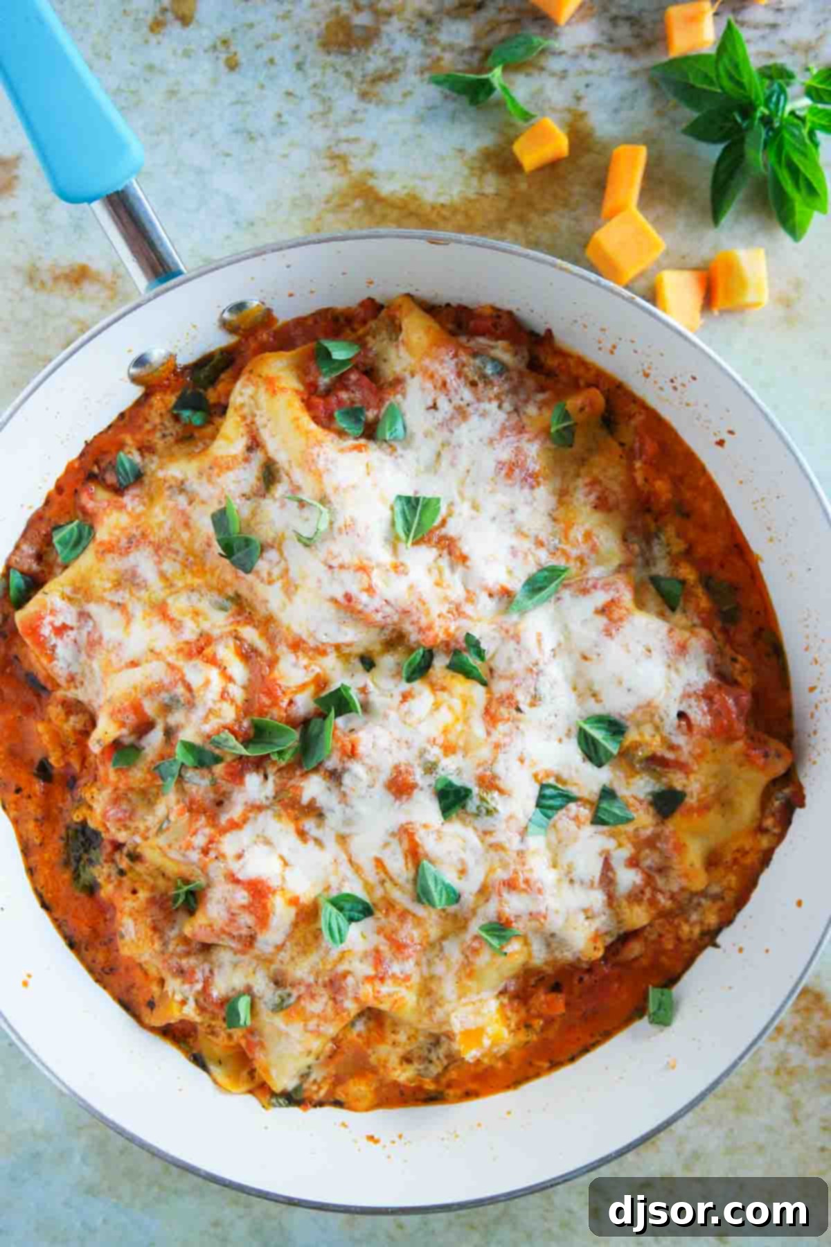 Savor the simplicity of this delicious Skillet Butternut Squash Lasagna, cooked entirely in one pan. Overhead shot of a rich and bubbling Skillet Butternut Squash Lasagna, showcasing its layers and melted cheese in a single pan.