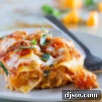 Hearty Butternut Squash Skillet Lasagna 2 A slice of golden-brown skillet butternut squash lasagna, showing layered pasta, creamy filling, and melted cheese.