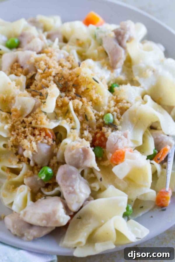 Close-up of Chicken Pot Pie Ragu, showing the creamy sauce coating the pasta and tender chicken pieces.
