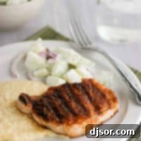 Smoky BBQ Pork Chops with Creamy Cheddar Grits 2 Barbecue pork chops over cheddar grits