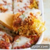 Spaghetti Lasagna 6 A delicious serving of Spaghetti Lasagna fresh out of the oven, garnished with herbs.