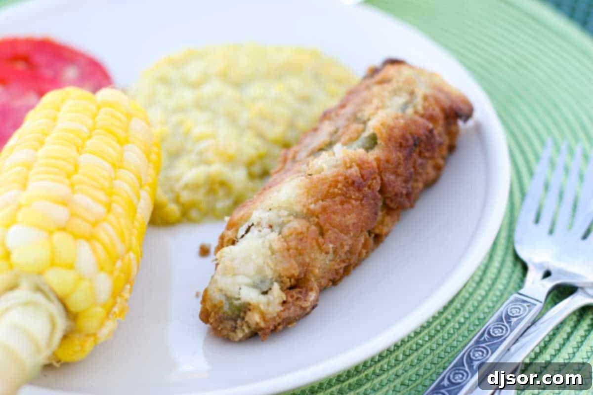 Homemade Chile Rellenos: A Childhood Favorite A golden-brown chile relleno on a plate, served alongside fresh corn and vibrant squash, evoking a taste of cherished family tradition.