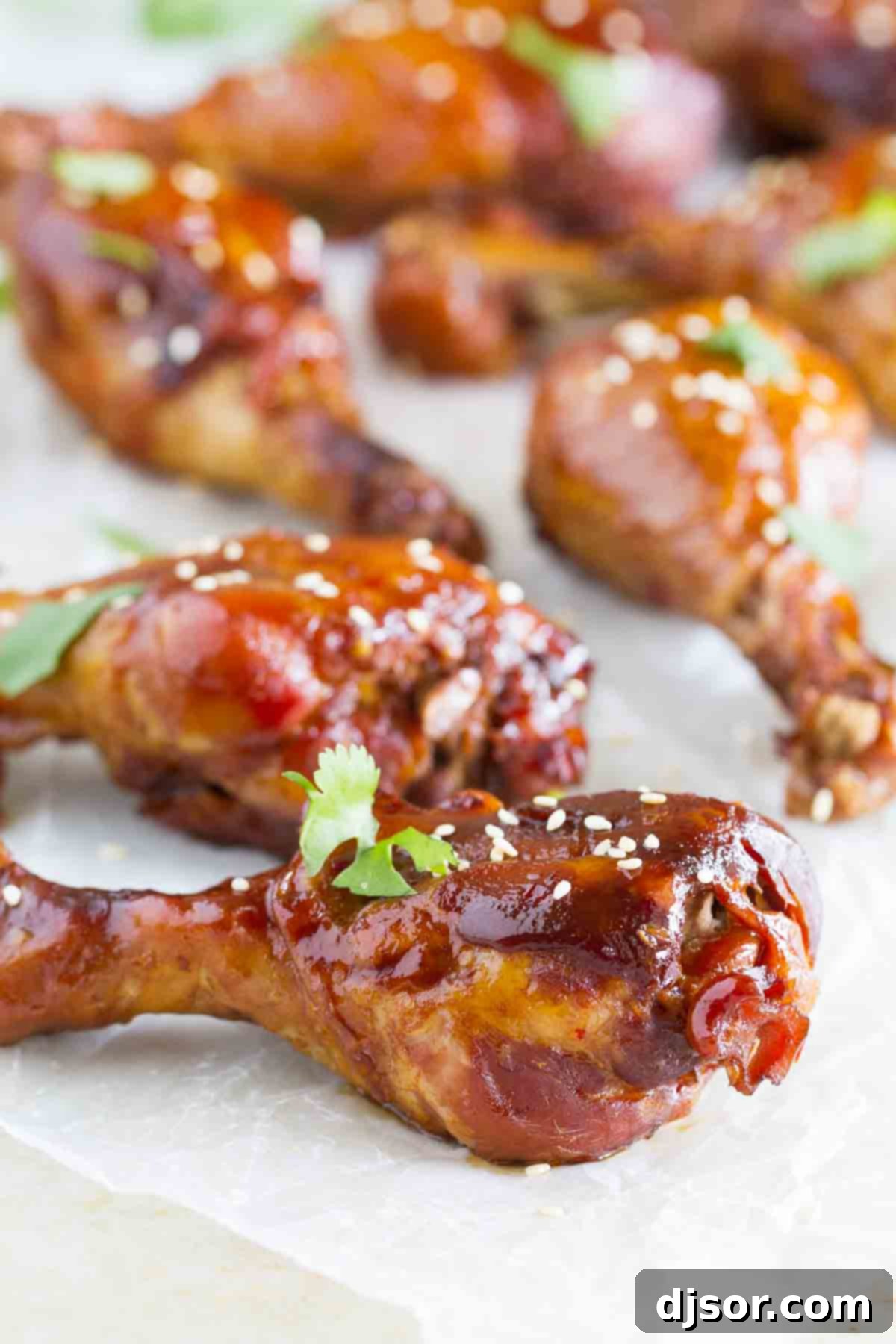 Practically dump and cook, these Slow Cooker Sweet Chili Chicken Drumsticks are full of Asian flavor and the slow cooker makes them easy as can be. Tender Slow Cooker Sweet Chili Chicken Drumsticks sprinkled with white sesame seeds, ready to serve.