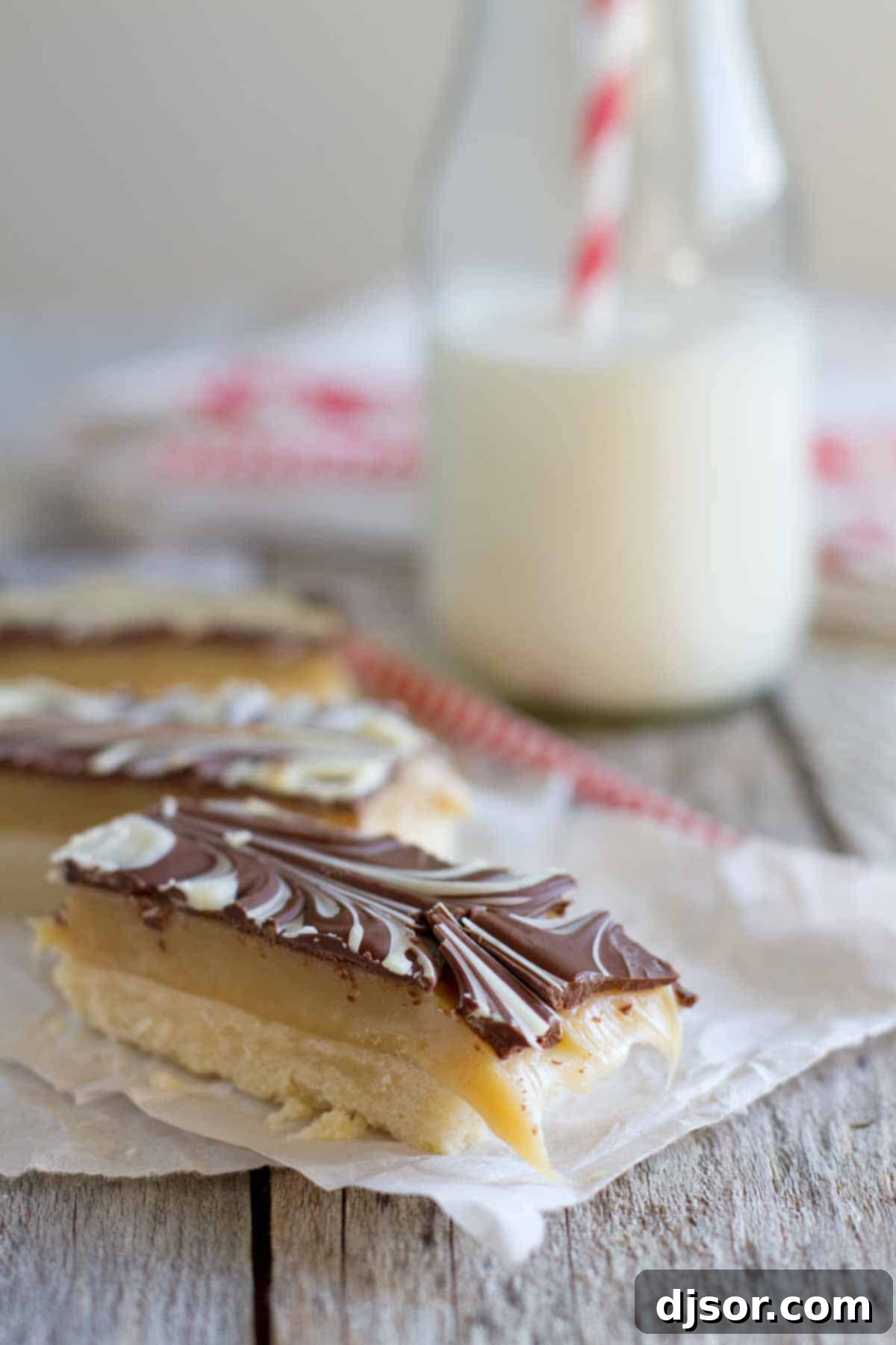 Marbled Caramel Chocolate Slice with a bite taken from it, showing the layered interior.