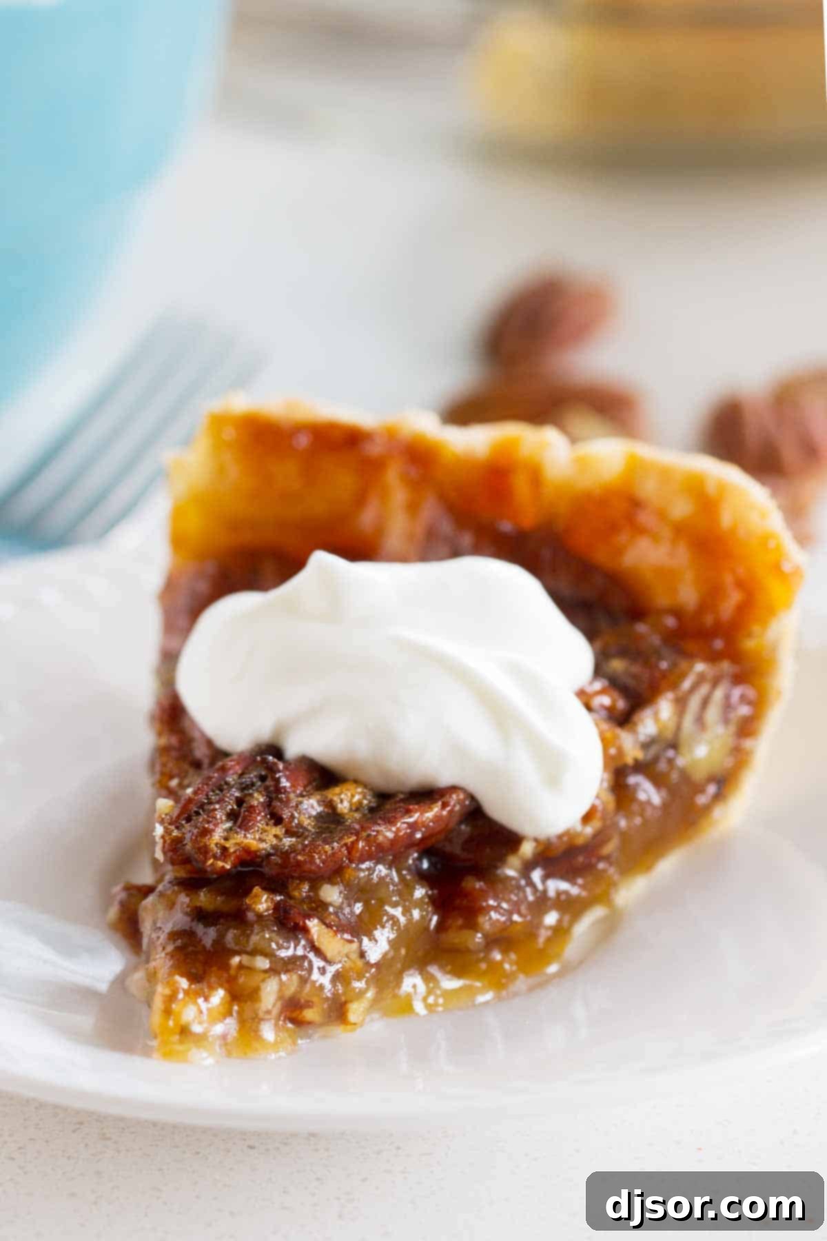 Classic Pecan Pie topped with freshly whipped cream, ready to be served for a special occasion.