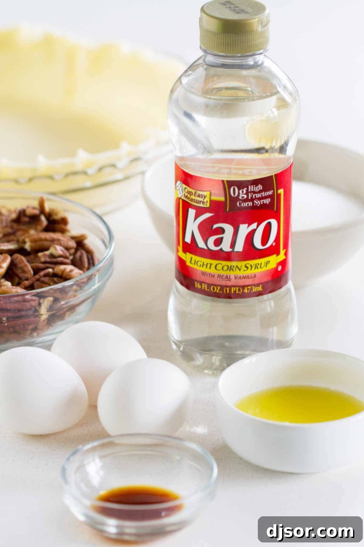 All the essential ingredients neatly arranged for a Classic Pecan Pie Recipe, highlighting fresh pecans and corn syrup.