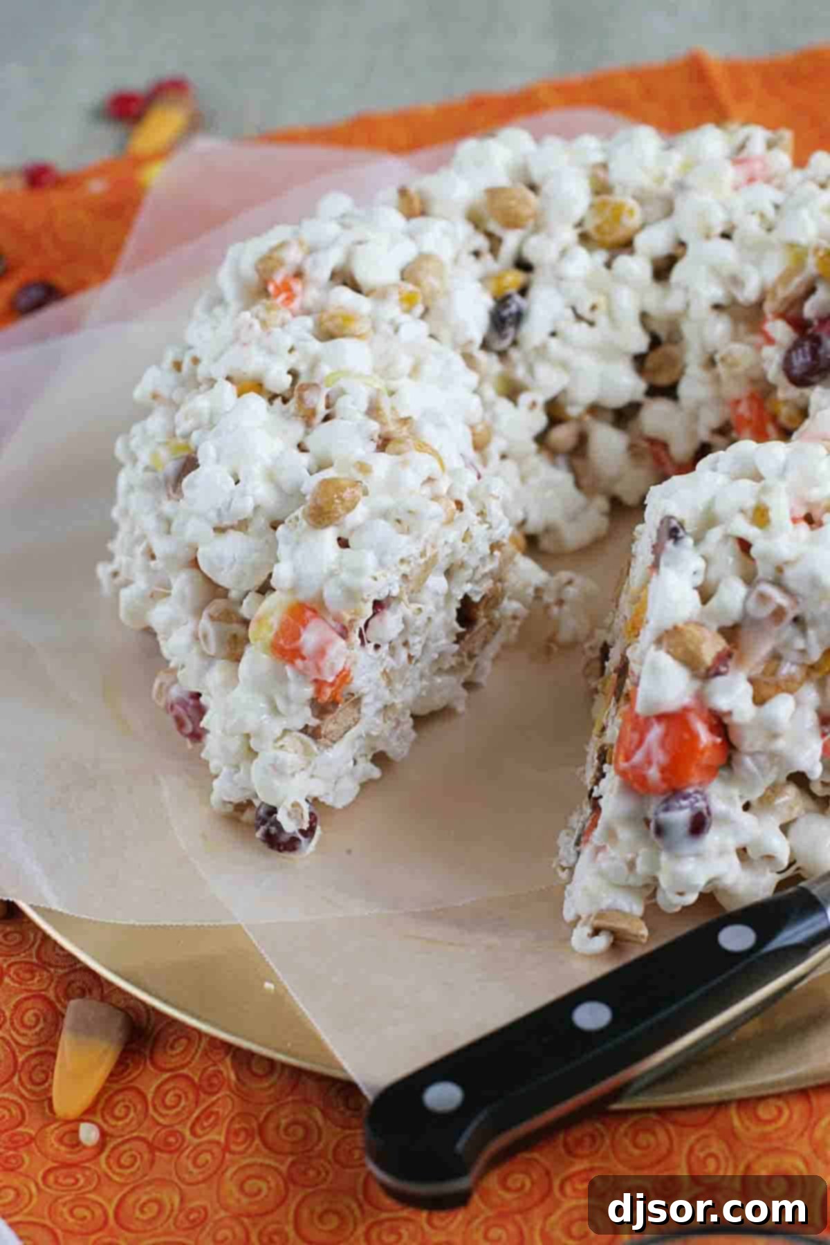 Halloween Popcorn Cake with a slice removed, revealing the delicious interior.