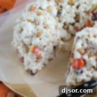 Halloween Popcorn Cake with a slice removed, revealing the delicious interior.