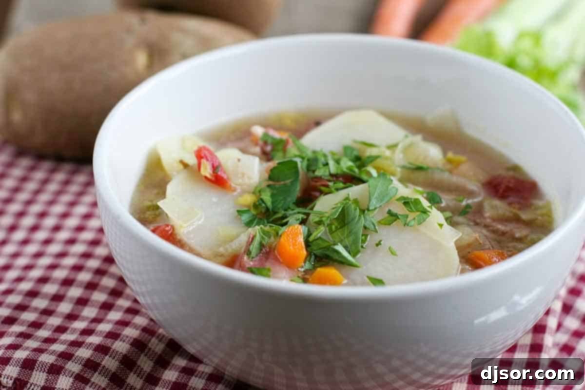 Bowl of Tomato and Potato Soup with Bacon topped with parsley.