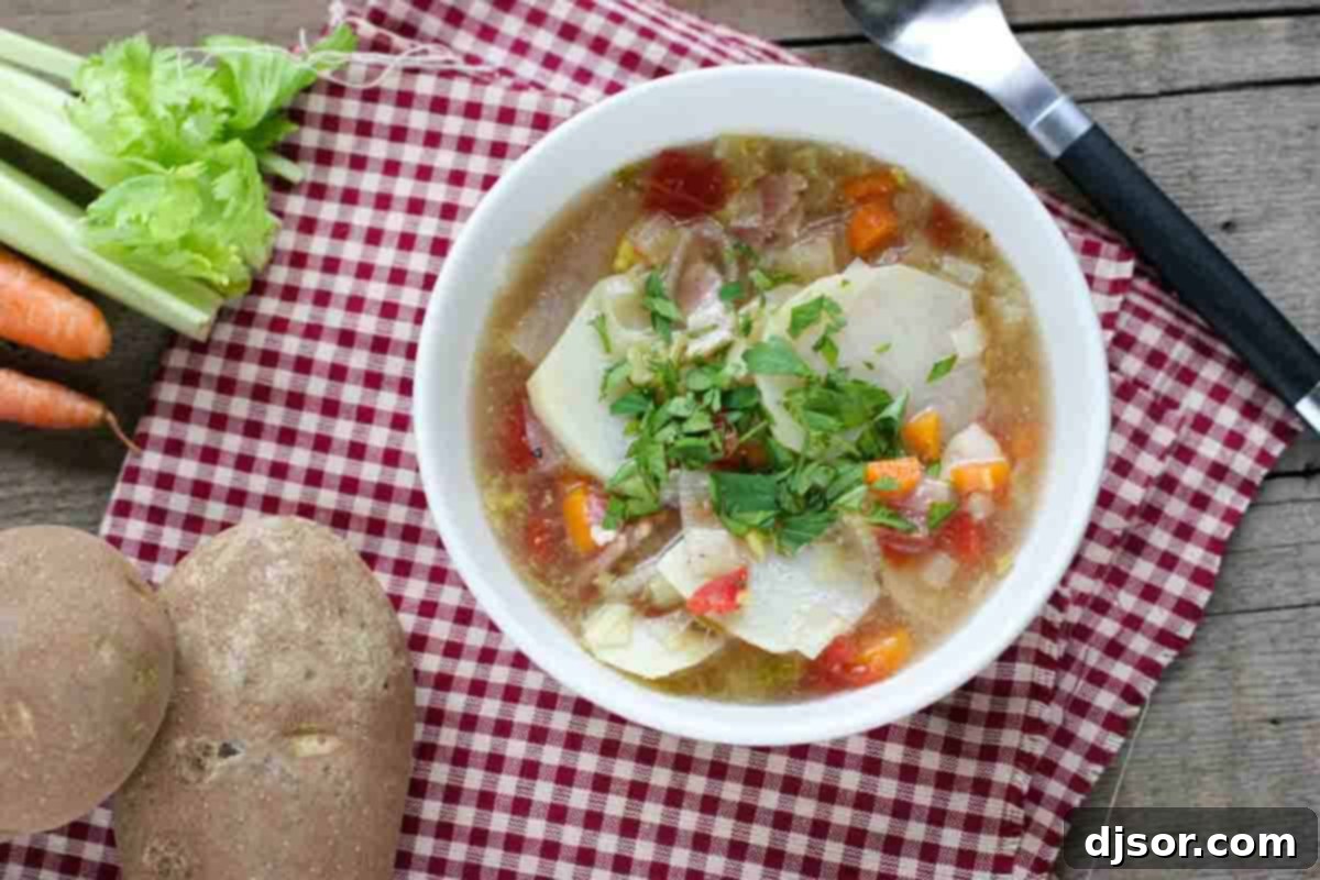 Bowl of Tomato and Potato Soup surrounded by ingredients.