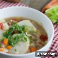 Bowl of Tomato and Potato Soup with Bacon on a red napkin.