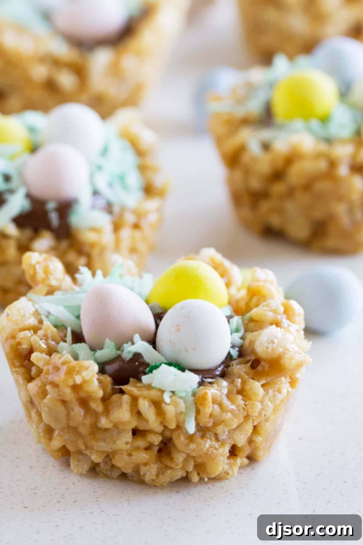 Finished Easter Basket Scotcheroos beautifully arranged, topped with melted chocolate, green tinted coconut, and colorful chocolate eggs, ready to be enjoyed.