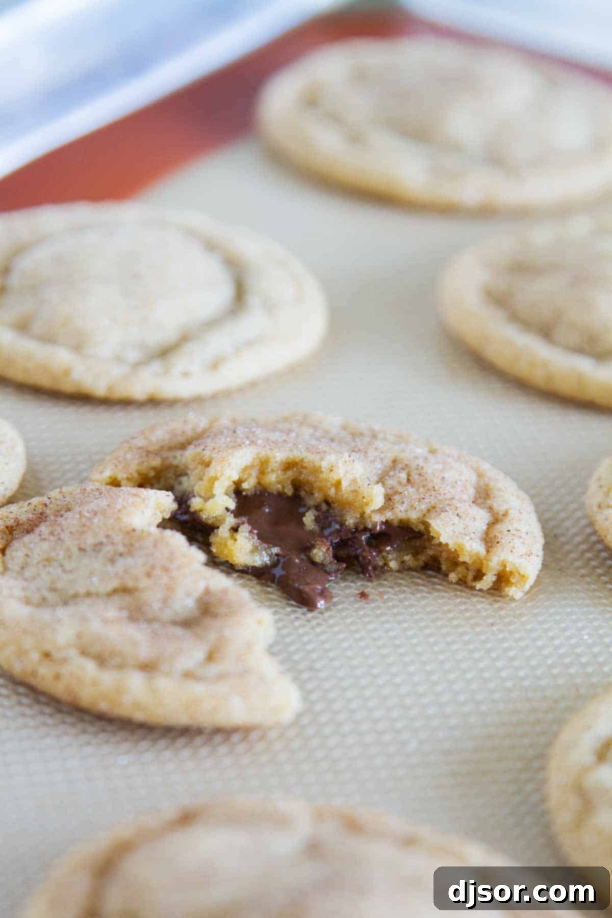 Peanut Butter Cinnamon Cloud Cookies 5 Freshly baked Peanut Butter Cinnamon Meltaway Cookies cooling on a baking sheet, glistening with cinnamon sugar.