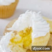 Lemon sunshine cupcake cut open to show the lemon filling in the center.