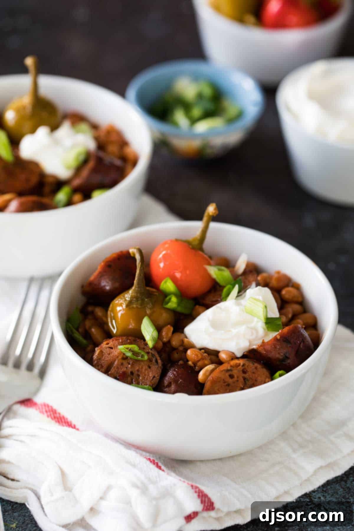 Slow Cooker Barbecue Beans and Sausage: A Hearty, Frugal Family Favorite Easy Crock Pot Beans and Sausage topped with sour cream.