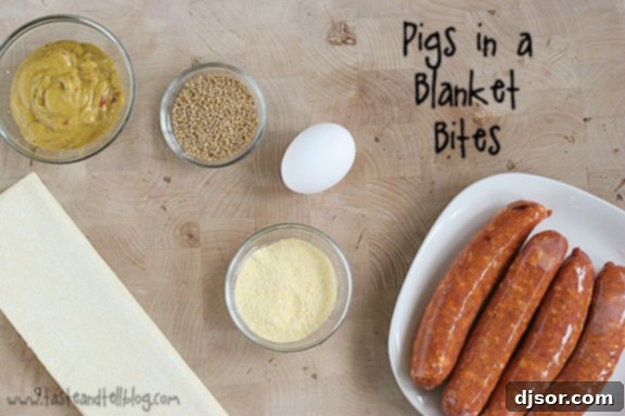 Close-up of baked Pigs in a Blanket Bites with andouille sausage and mustard seed coating.